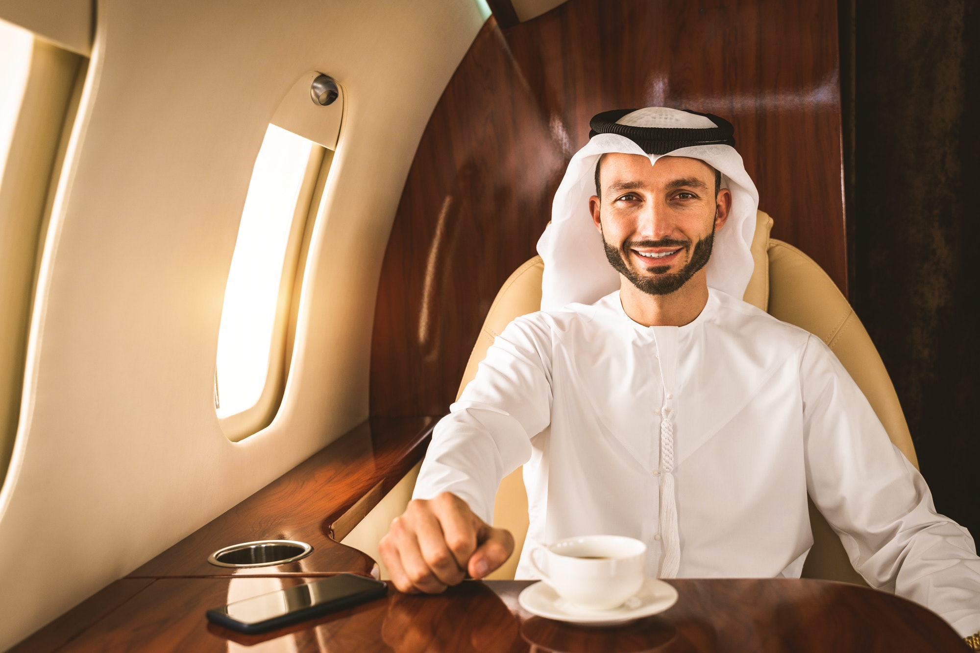 arabian-man-wearing-kandora-flying-on-private-jet.jpg